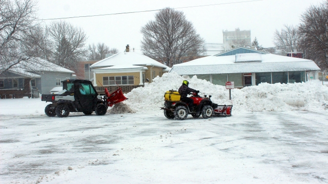 Everything that could move snow was pressed into service on Friday as towering snow piles grew. Photo by Edward Lynn.